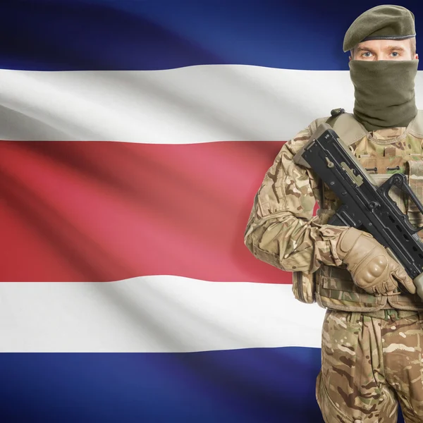 Soldier with machine gun and flag on background - Costa Rica — Stock Photo, Image