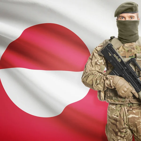 Soldier with machine gun and flag on background - Greenland — Stok Foto