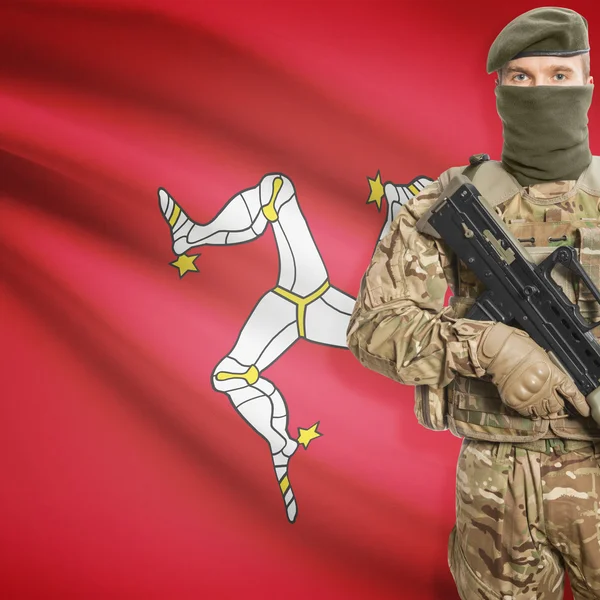 Soldier with machine gun and flag on background - Isle of Man — Stok Foto