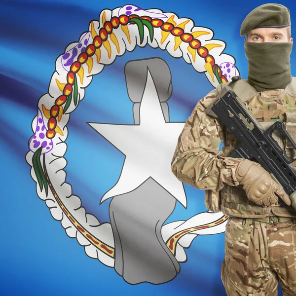Soldier with machine gun and flag on background - Northern Mariana Islands — Stok Foto
