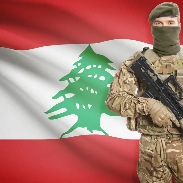 Soldier with machine gun and flag on background - Lebanon — Stock Photo, Image