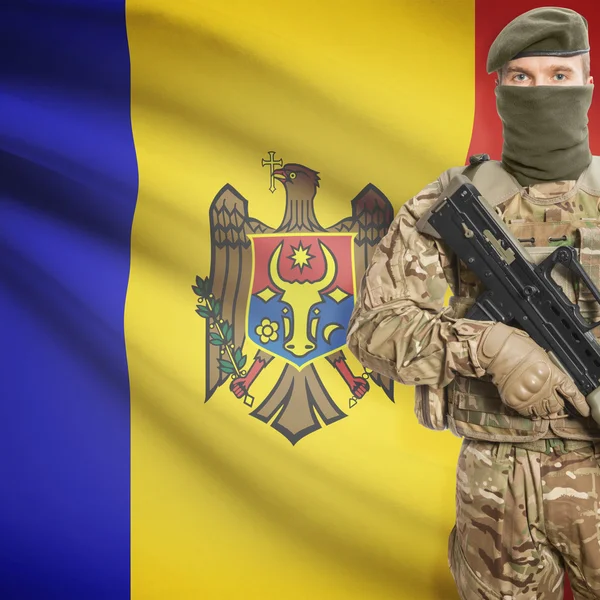 Soldier with machine gun and flag on background - Moldova