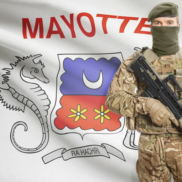 Soldier with machine gun and flag on background - Mayotte — Stok Foto