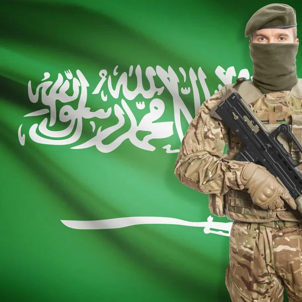 Soldier with machine gun and flag on background - Saudi Arabia — Stok Foto