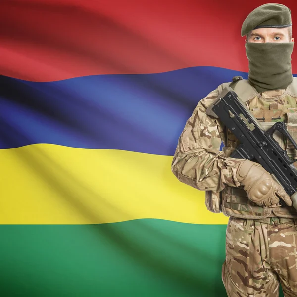 Soldier with machine gun and flag on background - Mauritius — Stok Foto