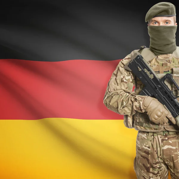 Soldier with machine gun and flag on background - Germany — Stock Photo, Image