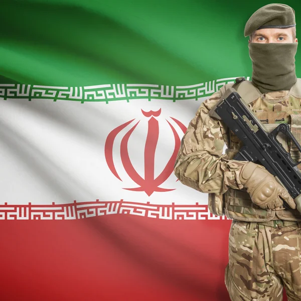 Soldier with machine gun and flag on background - Iran — Stok Foto