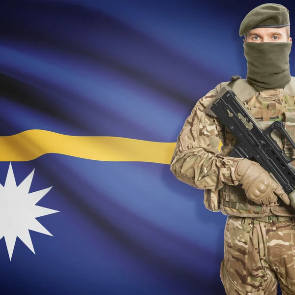 Soldier with machine gun and flag on background - Nauru — Stok Foto