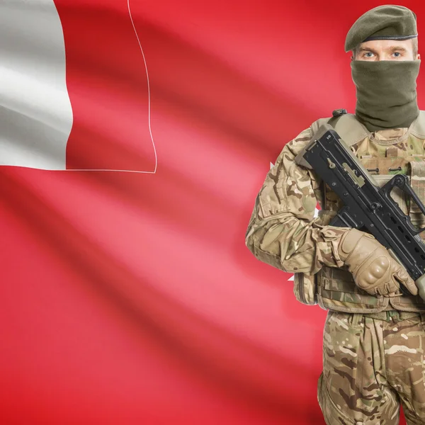 Soldat mit Maschinengewehr und Flagge auf Hintergrund - Wallis und Futuna — Stockfoto
