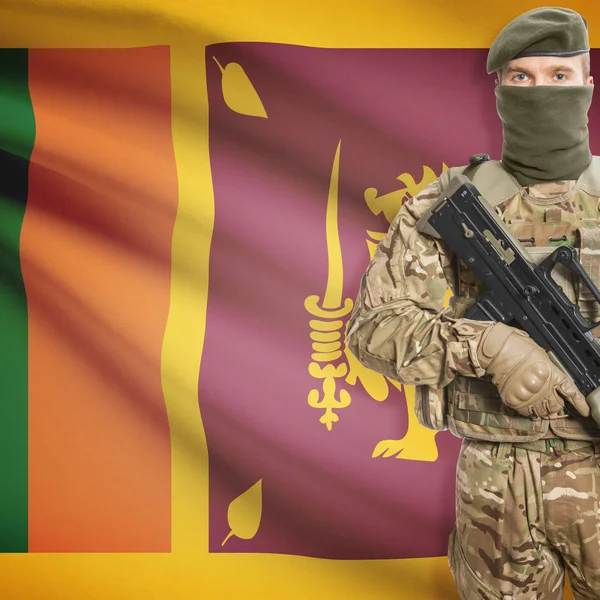 Soldier with machine gun and flag on background - Sri Lanka — Stockfoto