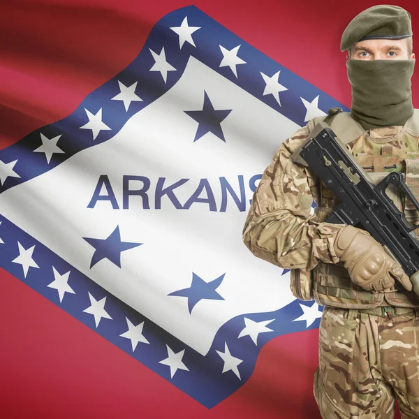 Soldier with machine gun and USA state flag on background - Arkansas — Stock Photo, Image