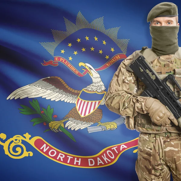 Soldier with machine gun and USA state flag on background - North Dakota — Stok Foto