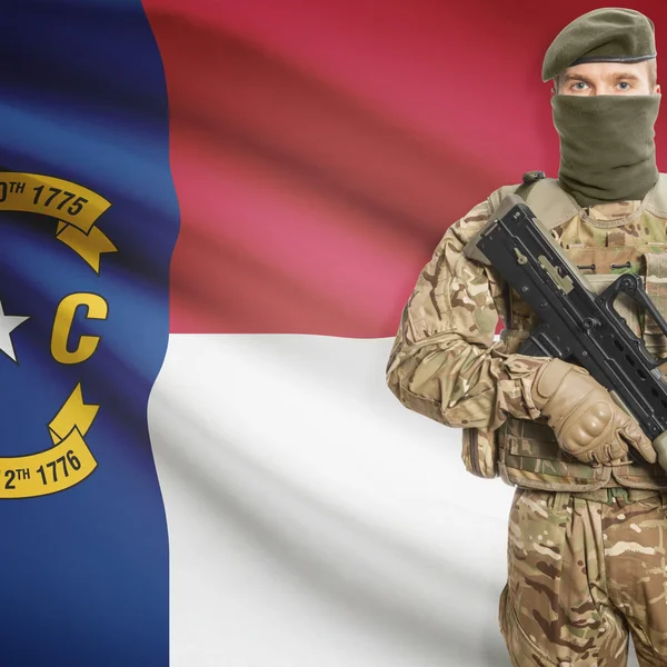 Soldier with machine gun and USA state flag on background - North Carolina — Stok fotoğraf