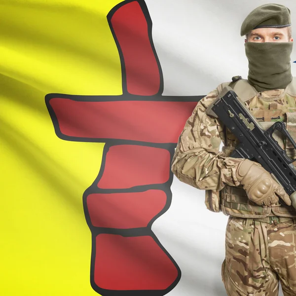 Soldier with machine gun and Canadian province flag on background series - Nunavut — стокове фото