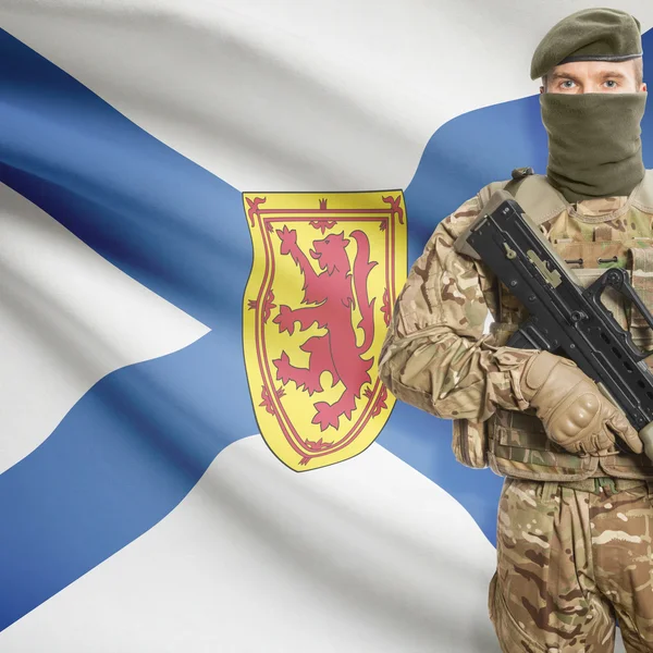 Soldier with machine gun and Canadian province flag on background series - Nova Scotia — Stok Foto