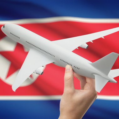 Uçağın içinde el ile arka plan serisi - Kuzey Kore bayrağı