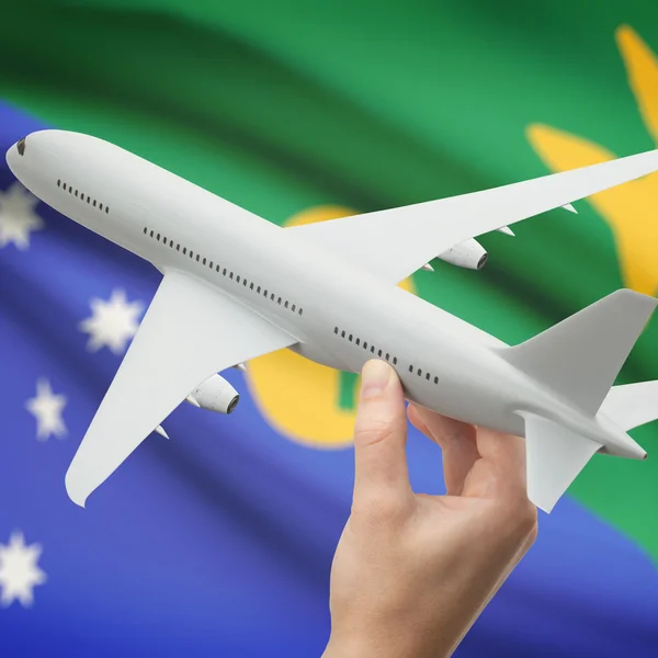 Avión en la mano con la bandera en la serie de fondo - isla de Navidad —  Fotos de Stock