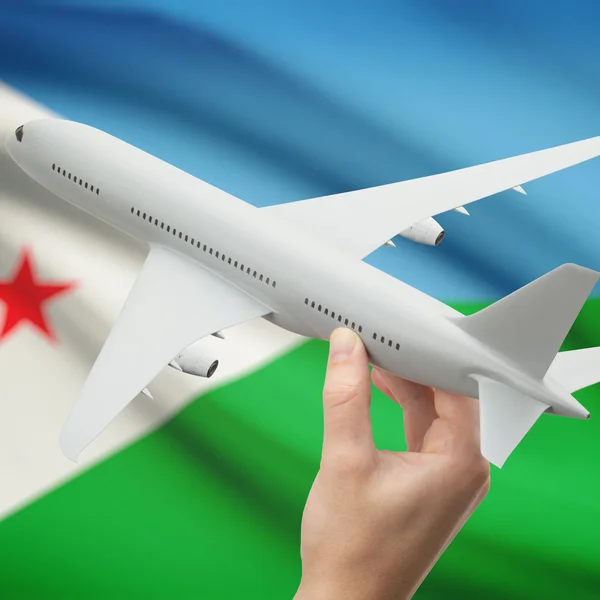 Airplane in hand with flag on background series - Djibouti — Stock Photo, Image