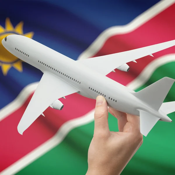 Самолет в руку с флагом на фоне серии - Намибия — стоковое фото