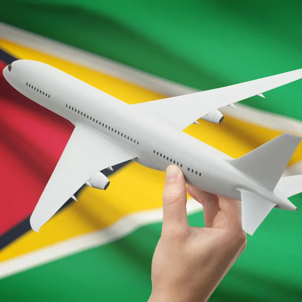 Airplane in hand with flag on background series - Guyana — Stock Photo, Image