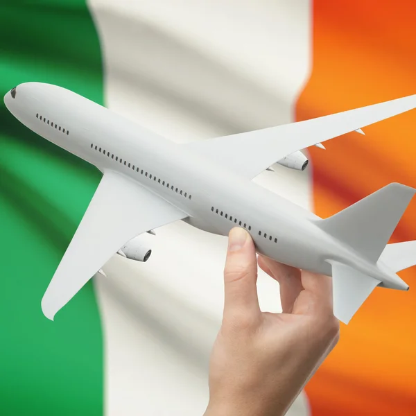 Airplane in hand with flag on background series - Ireland — Stock Photo, Image