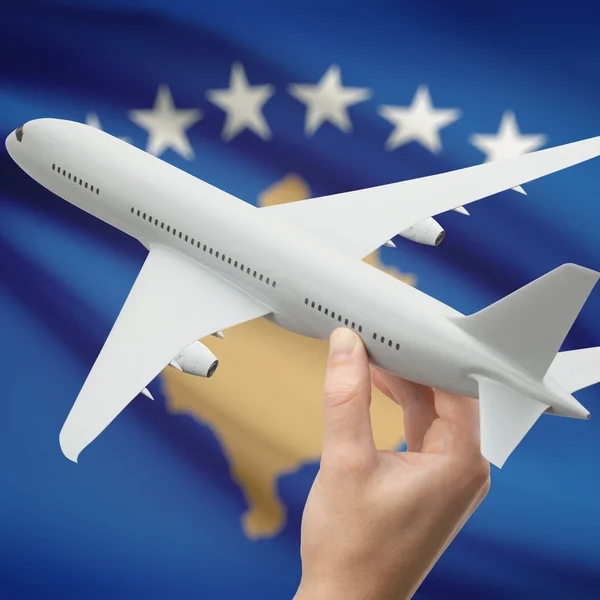 Airplane in hand with flag on background series - Kosovo — Stock Photo, Image