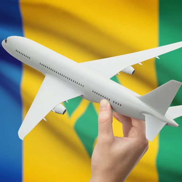 Flugzeug in der Hand mit Flagge auf Hintergrund-Serie - St. Vincent und die Grenadinen — Stockfoto