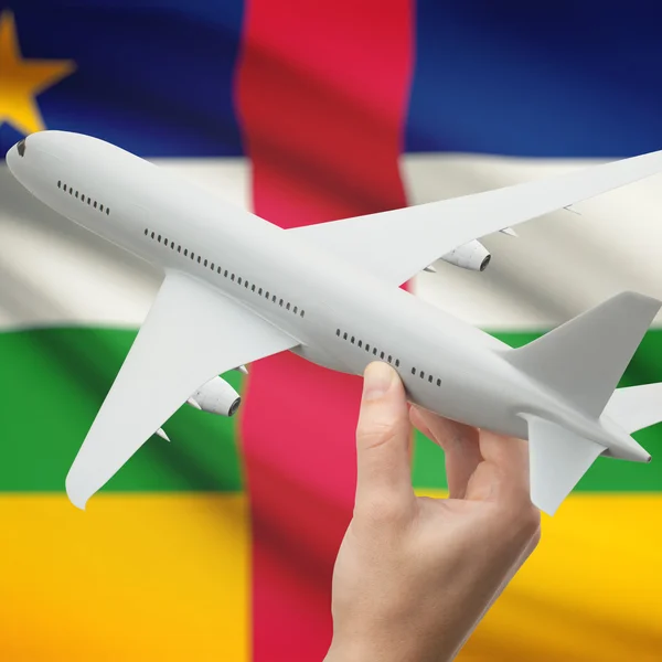 Vliegtuig in hand met vlag op achtergrond serie - centrale Afrikaanse Repub — Stockfoto