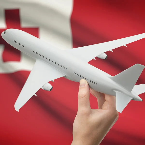 Airplane in hand with flag on background series - Tonga — Stock Photo, Image