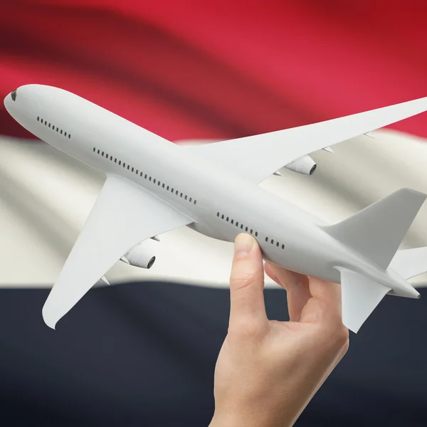 Airplane in hand with flag on background series - Yemen — Stock Photo, Image