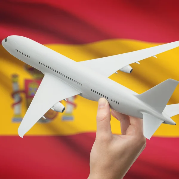 Avión en la mano con la bandera en la serie de fondo - España —  Fotos de Stock