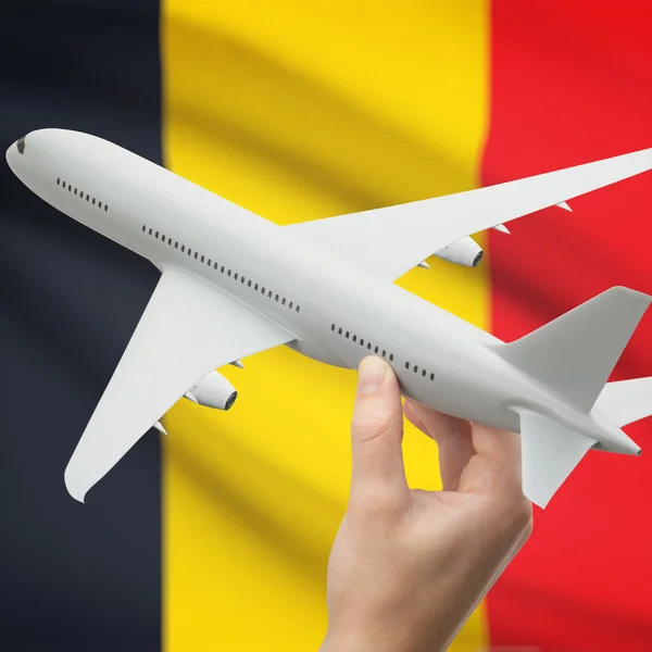 Airplane in hand with flag on background series - Belgium — Stock Photo, Image