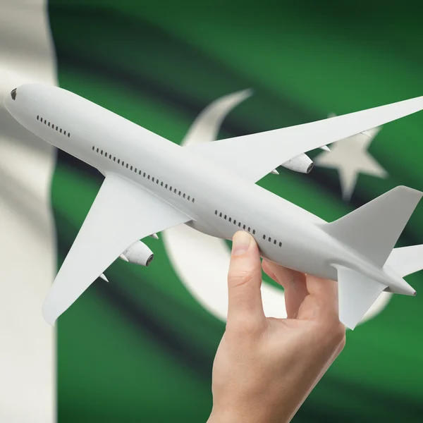 Airplane in hand with flag on background series - Pakistan — Stock Photo, Image