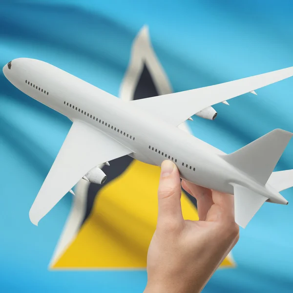 Flugzeug in der Hand mit Flagge auf Hintergrund-Serie - Saint Lucia — Stockfoto