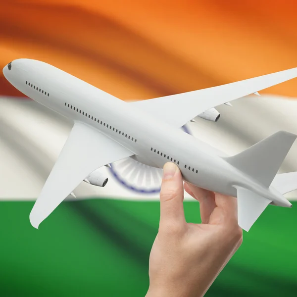 Airplane in hand with flag on background series - India — Stock Photo, Image
