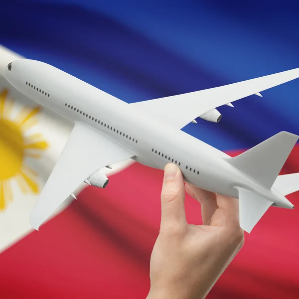 Airplane in hand with flag on background series - Philippines — Stock Photo, Image