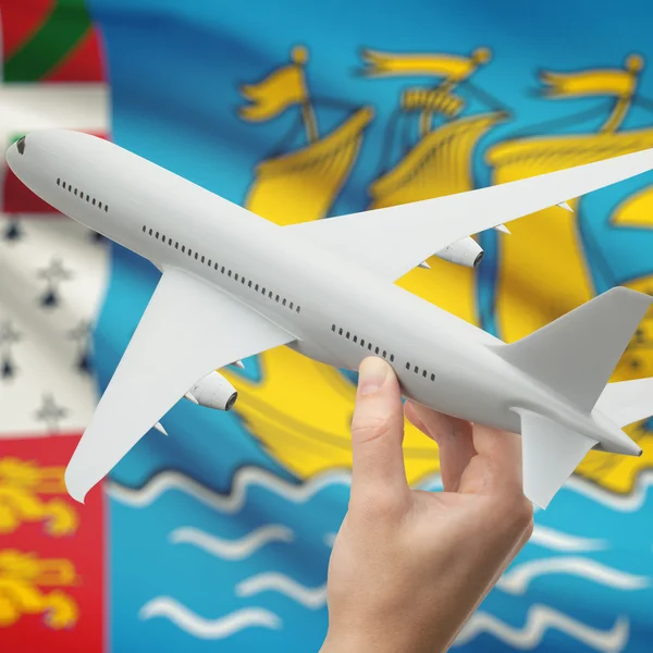 Flugzeug in der Hand mit Flagge auf Hintergrund-Serie - Saint-Pierre und Miquelon — Stockfoto
