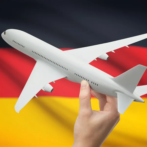 Airplane in hand with flag on background series - Germany — kuvapankkivalokuva