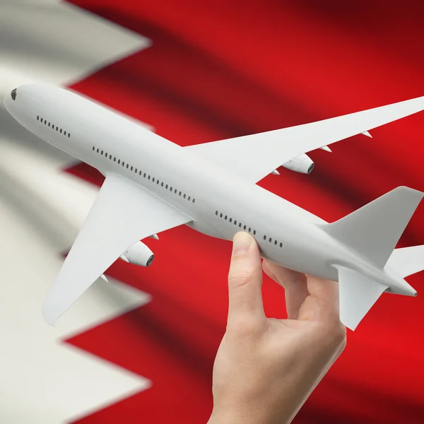 Airplane in hand with flag on background series - Bahrain — Stock Photo, Image