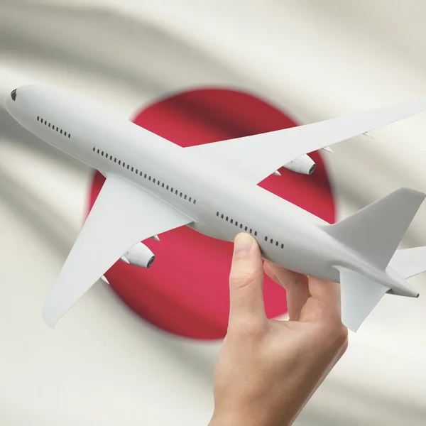 Avião na mão com a bandeira na série de fundo - Japão — Fotografia de Stock