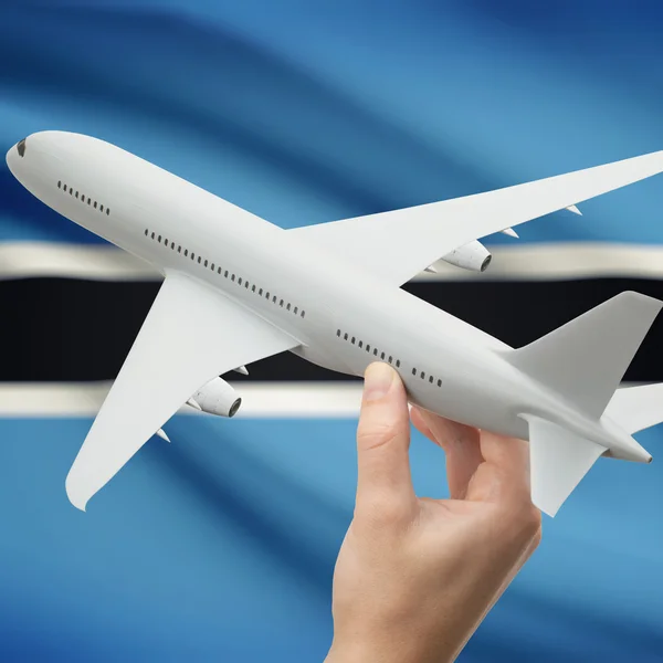 Vliegtuig in hand met vlag op achtergrond series - Botswana — Stockfoto