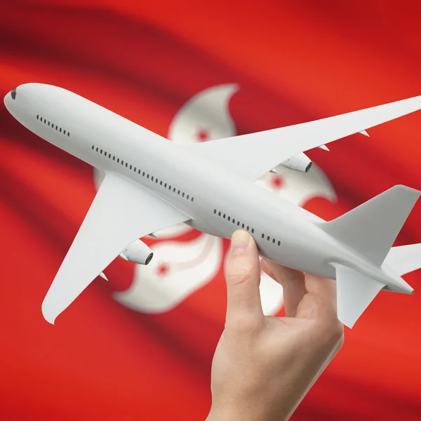 Airplane in hand with flag on background series - Hong Kong — Stock Photo, Image