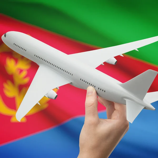 Airplane in hand with flag on background series - Eritrea — Stock Photo, Image