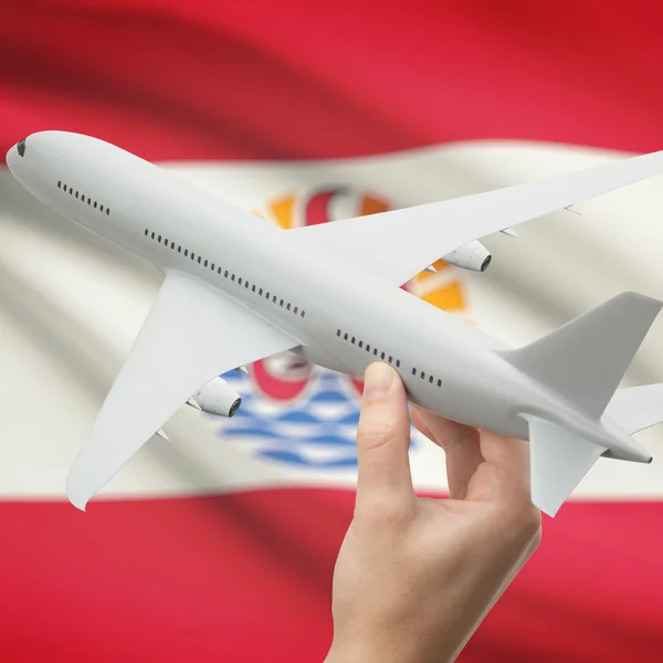 Airplane in hand with flag on background series - French Polynesia — Stock Photo, Image