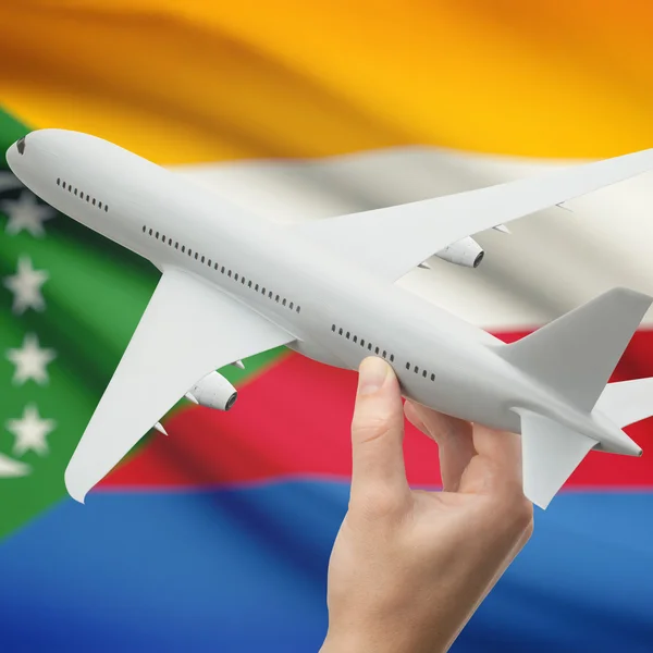 Uçak ile arka plan serisi - Komor bayrağı elinde — Stok fotoğraf