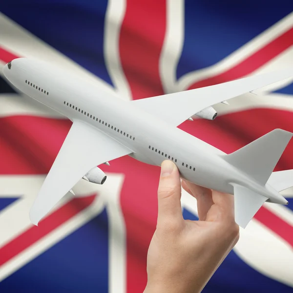 Airplane in hand with flag on background series - United Kingdom — Stock Photo, Image