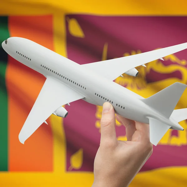 Flugzeug in der Hand mit Flagge auf Hintergrund-Serie - Sri Lanka — Stockfoto