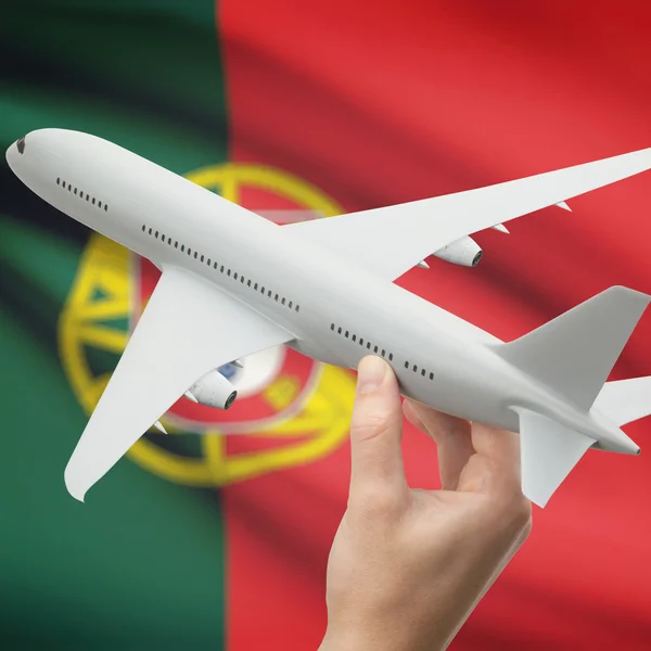 Airplane in hand with flag on background series - Portugal — Stock Photo, Image