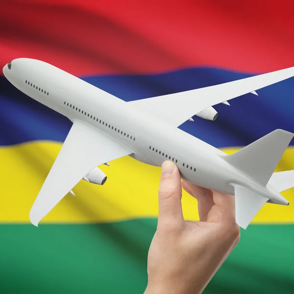 Vliegtuig in hand met vlag op achtergrond serie - Mauritius — Stockfoto