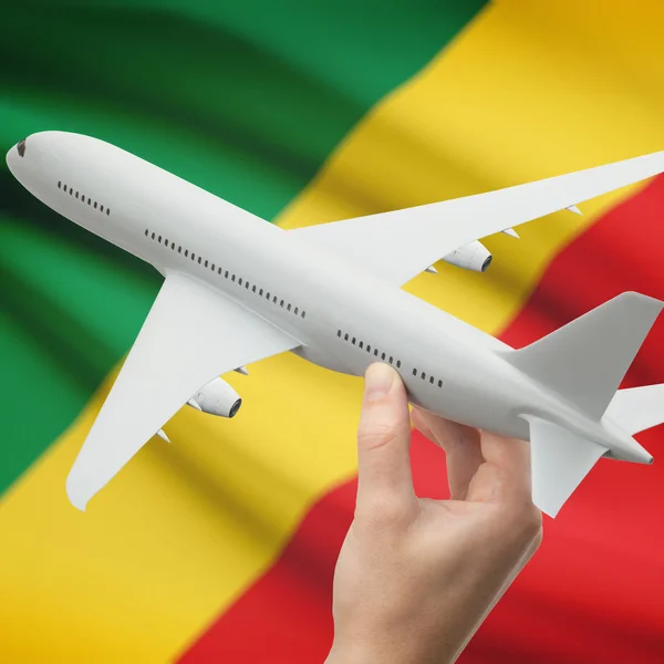 Airplane in hand with flag on background series - Congo-Brazzaville — Stock Photo, Image